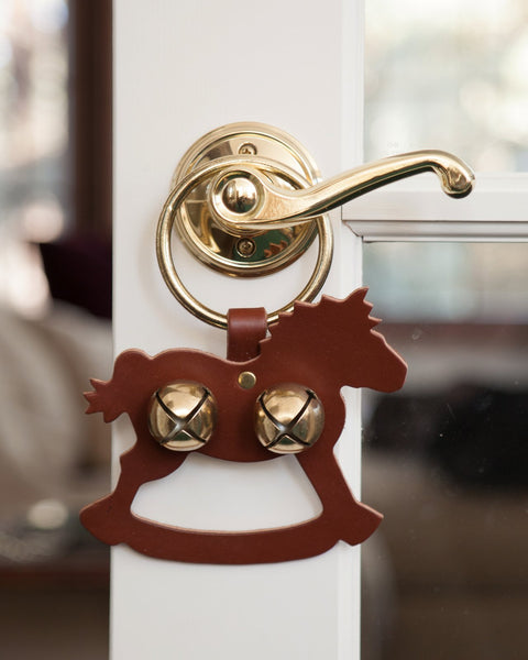 door decoration rocking horse brown gold bells